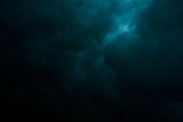 a large body of water under a cloudy sky